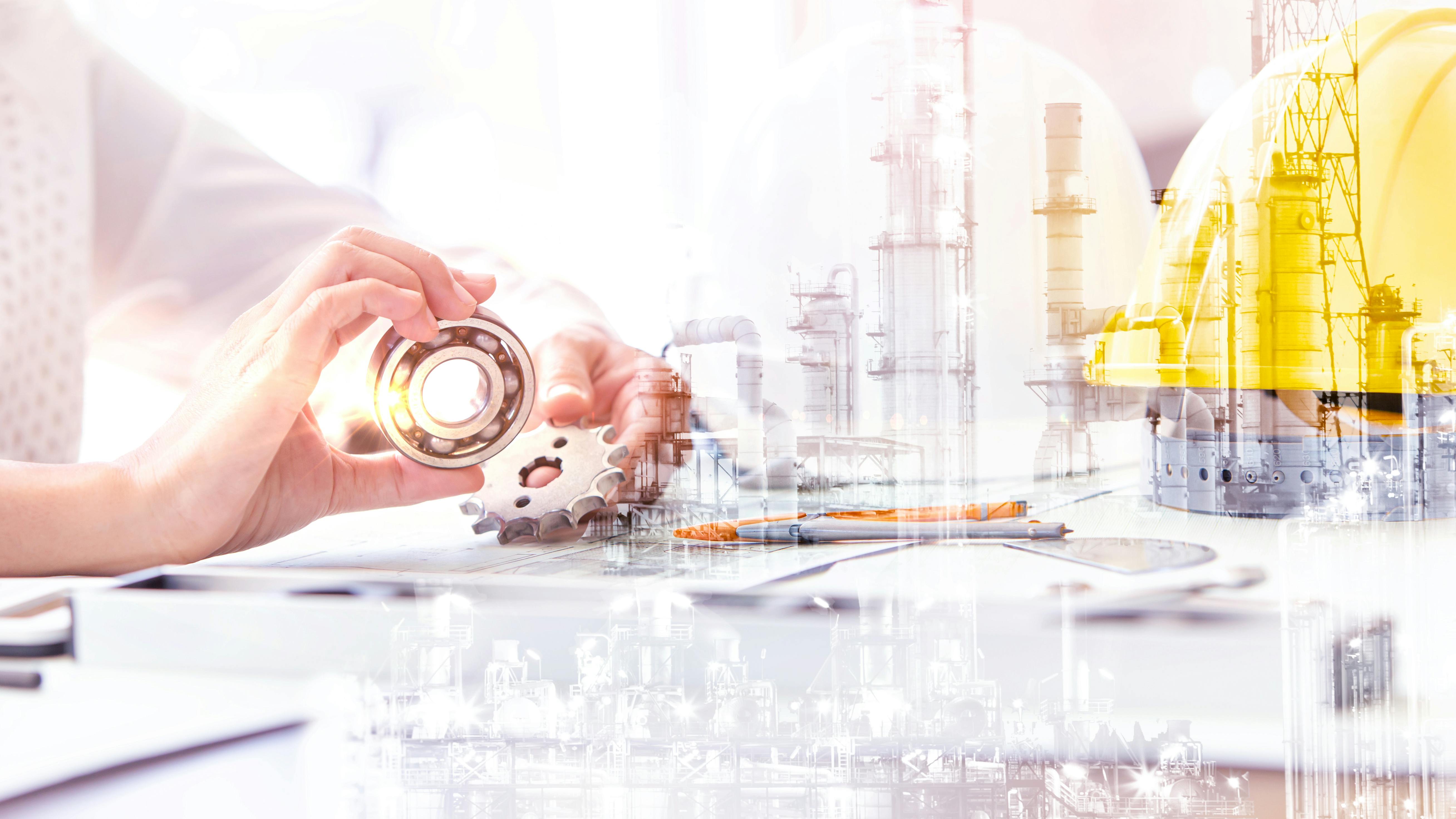person holding gears with hard hat and industrial plant transposed into image