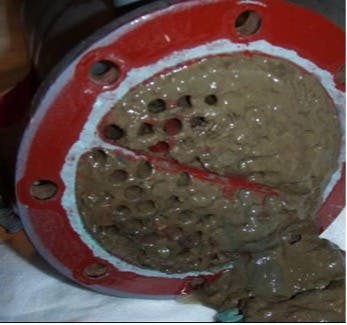 Figure 1. Heat exchanger fouled with microbiological slime and silt from a poorly functioning biocide program. (1)
