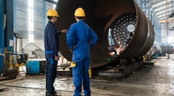 two workers inspect a vessel two workers inspect a vessel