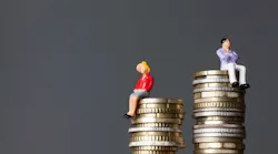 Miniature Figure Of A Man And Women Sit On Stacks Of Coin, But Female's Stack Of Coins Is Less Than The Male's