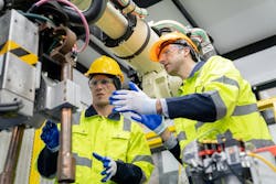 Engineer working wearing personal protection equipment PPE, hard hat and other safety apparel Engineer working wearing personal protection equipment PPE, hard hat and other safety apparel