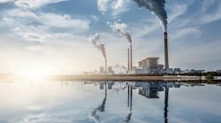 Chemical plant along waterfront against blue sky background Chemical plant along waterfront against blue sky background