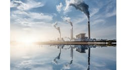 Chemical plant along waterfront against blue sky background Chemical plant along waterfront against blue sky background