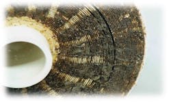 Figure 1: Example of organic fouling (brown deposits) in a spiral wound polymer separations membrane. Figure 1: Example of organic fouling (brown deposits) in a spiral wound polymer separations membrane.