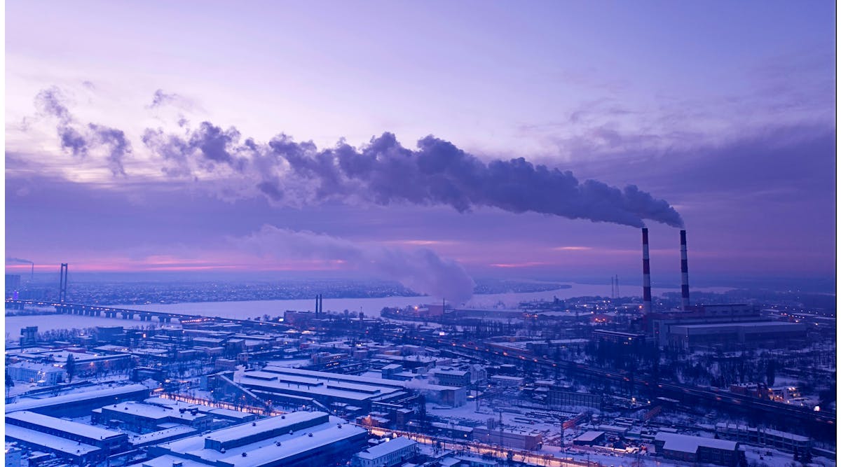 Smoke stacks emitting harmful emissions into the atmosphere causing global warming.