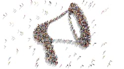 Large group of people seen from above gathered together as a megaphone symbol