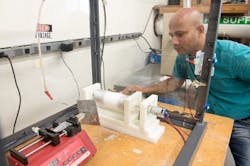 Sujit Bidhar, an engineer and researcher at Fermilab, works on an electrospinning experiment. The technique for producing ceramic nanofibers could make the materials more accessible and affordable Sujit Bidhar, an engineer and researcher at Fermilab, works on an electrospinning experiment. The technique for producing ceramic nanofibers could make the materials more accessible and affordable