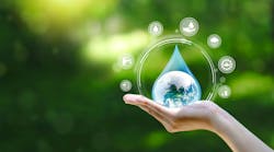 Water drop in hand against natural background Water drop in hand against natural background