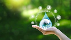 Water drop in hand against natural background Water drop in hand against natural background