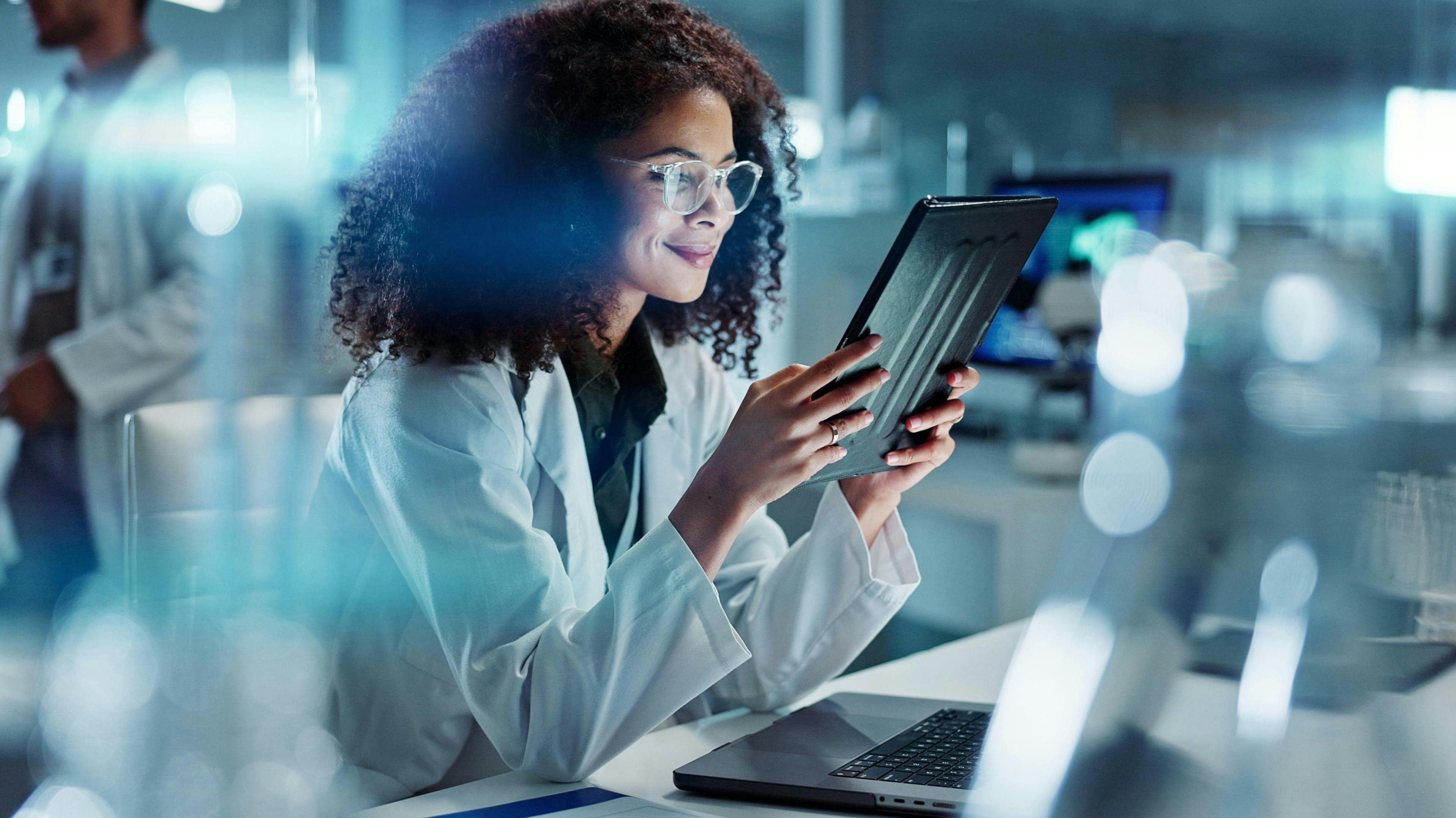Female scientist reading feedback on a tablet