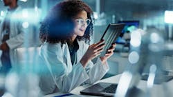 Female scientist reading feedback on a tablet Female scientist reading feedback on a tablet