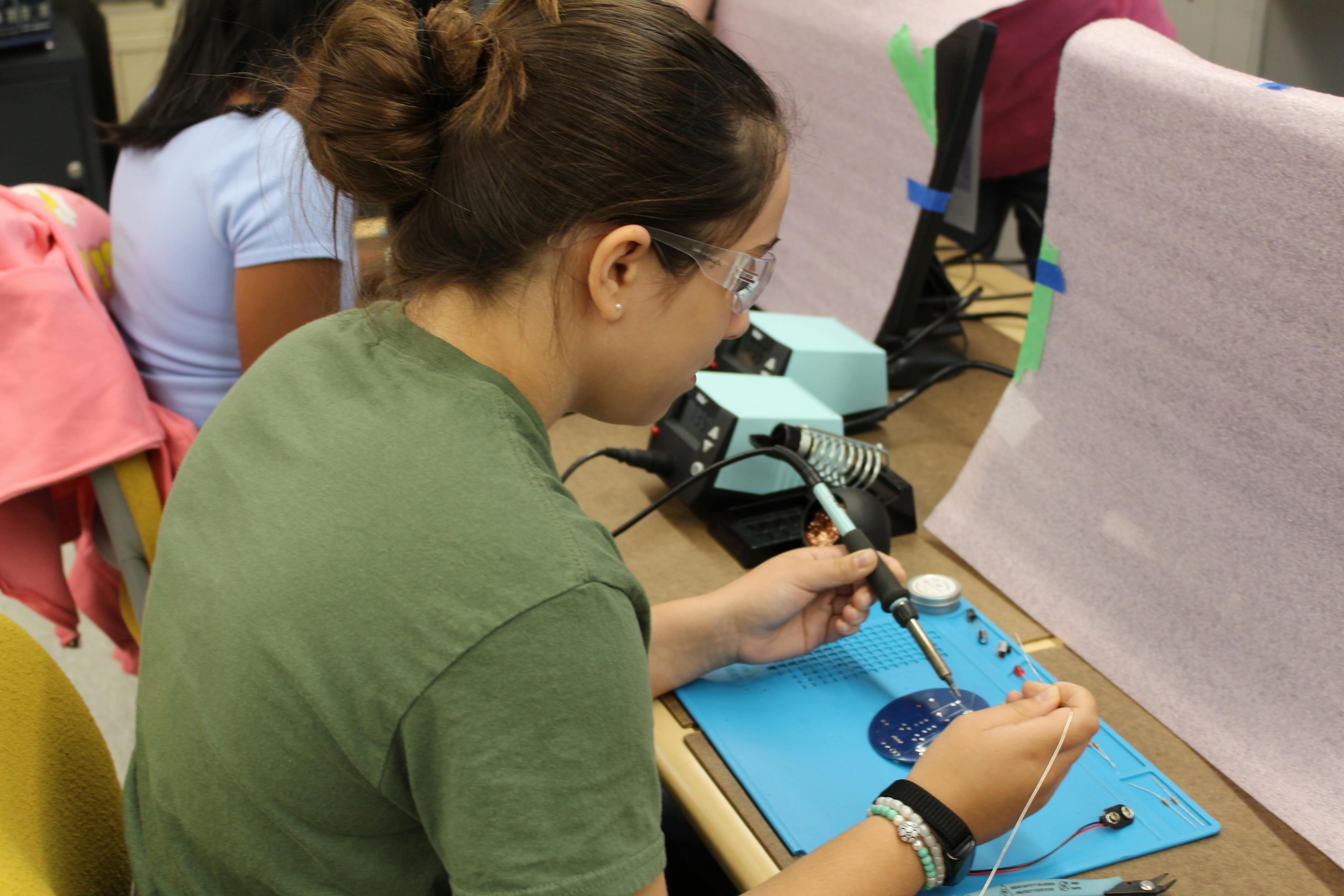 STEM camper doing soldering project