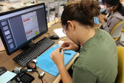 In this two-week STEM camp, students learned to solder and are seen here working on a soldering project. In this two-week STEM camp, students learned to solder and are seen here working on a soldering project.