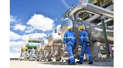 workers in an industrial plant for the production and processing of crude oil workers in an industrial plant for the production and processing of crude oil
