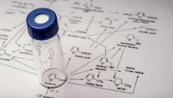 Sample vial on paper with chemical formula Sample vial on paper with chemical formula