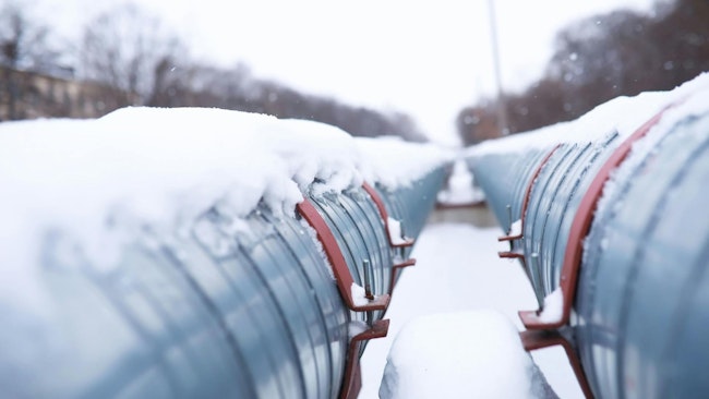 Winter landscape with the snow-covered gas pipeline and trees