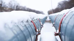 Winter landscape with the snow-covered gas pipeline and trees