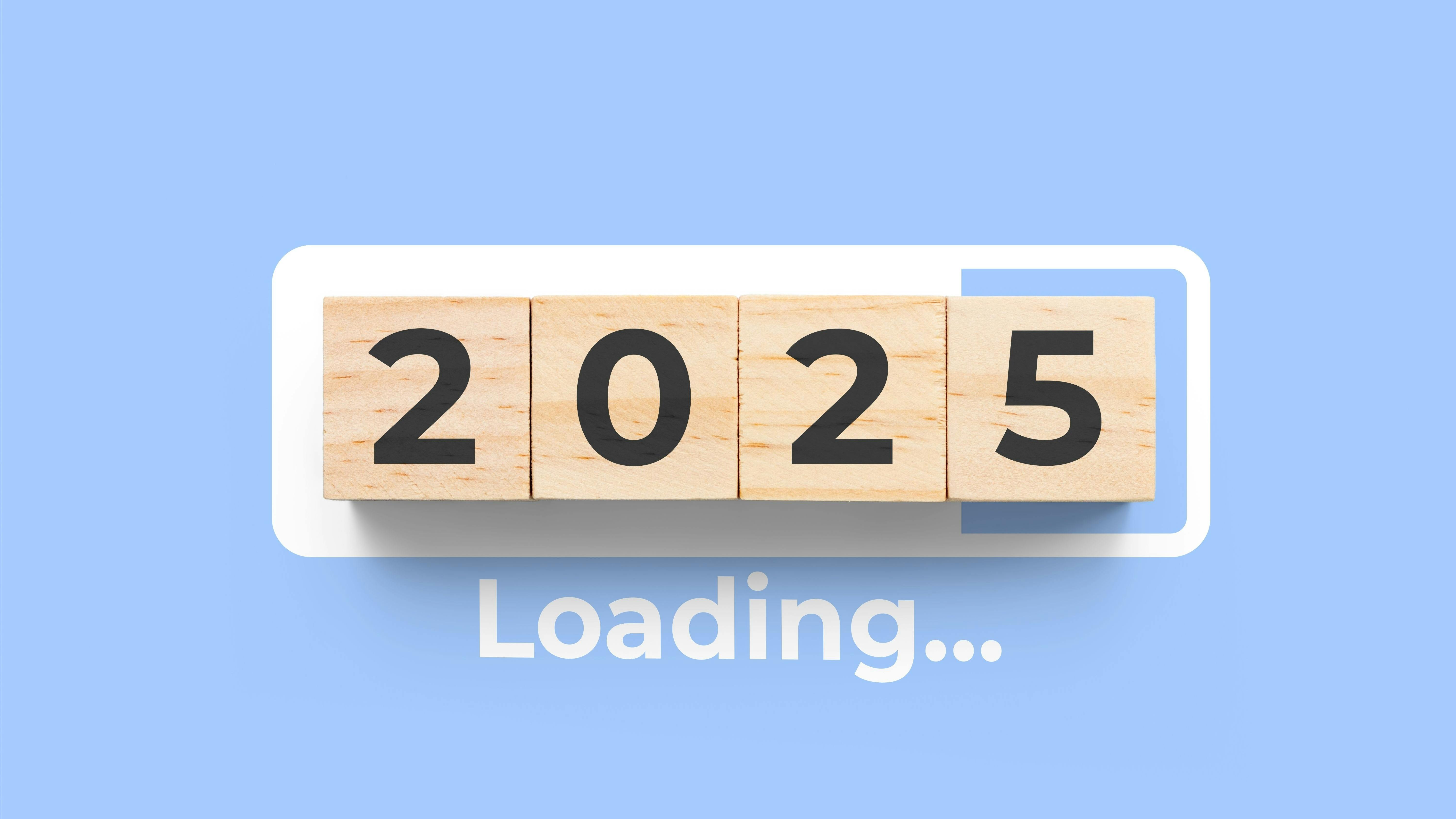 wooden blocks displaying 2025 with the the text 'Loading....' on a blue background