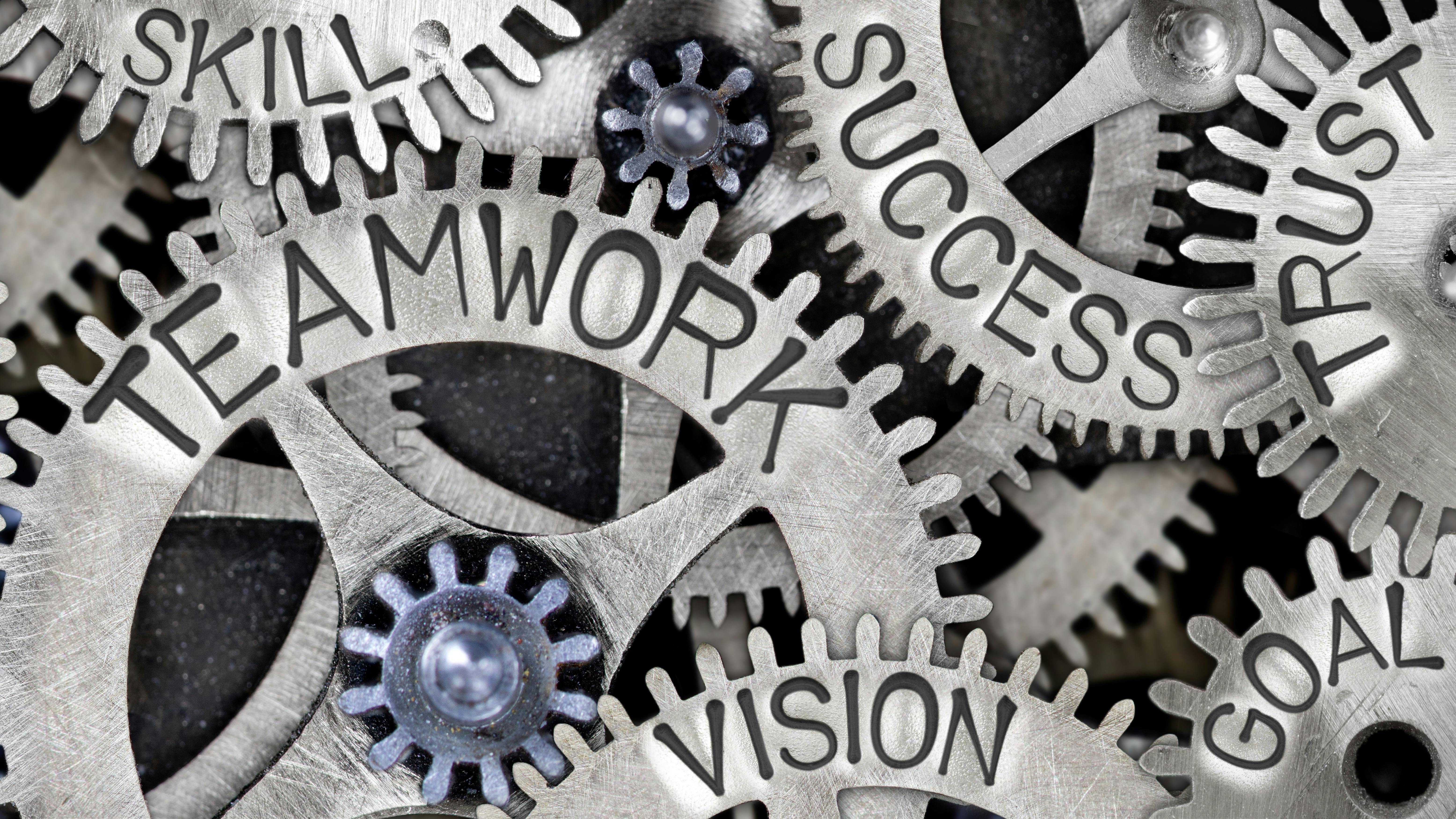 Words Teamwork, Vision, Goal, Trust, Success, Skill, Partner displayed on gears
