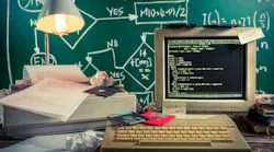 an early personal computer with hard disks drives and dot matrix printer paper and equations written on a chalkboard in the background