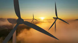 Wind turbine silhouette at sunrise