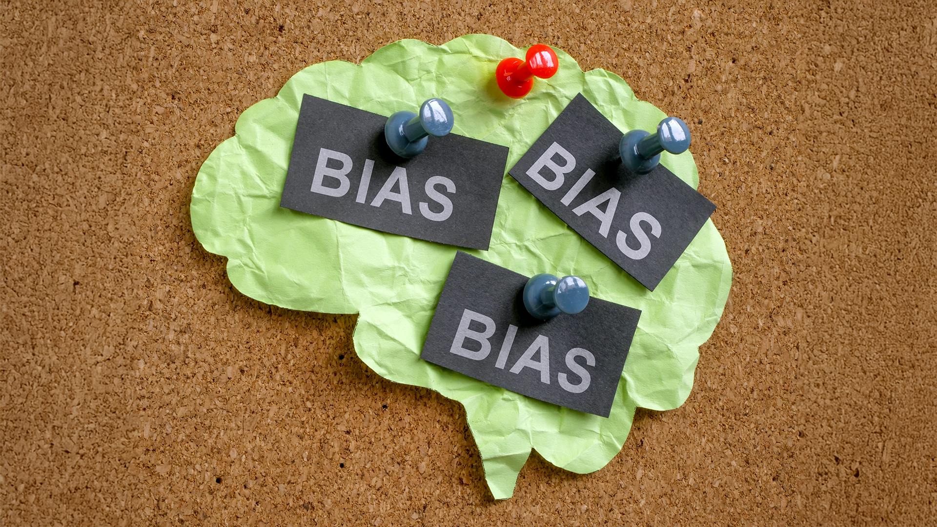 Paper brain and tacks with word bias.