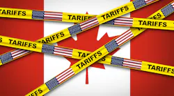 Canadian flag covered by caution tape displaying US flag and the word tariffs
