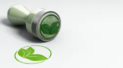 Rubber stamp over paper background with leaves symbol printed on it.