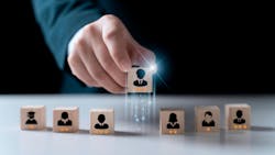 Hand chooses a wooden people standing out from the crowd. Hand chooses a wooden people standing out from the crowd.