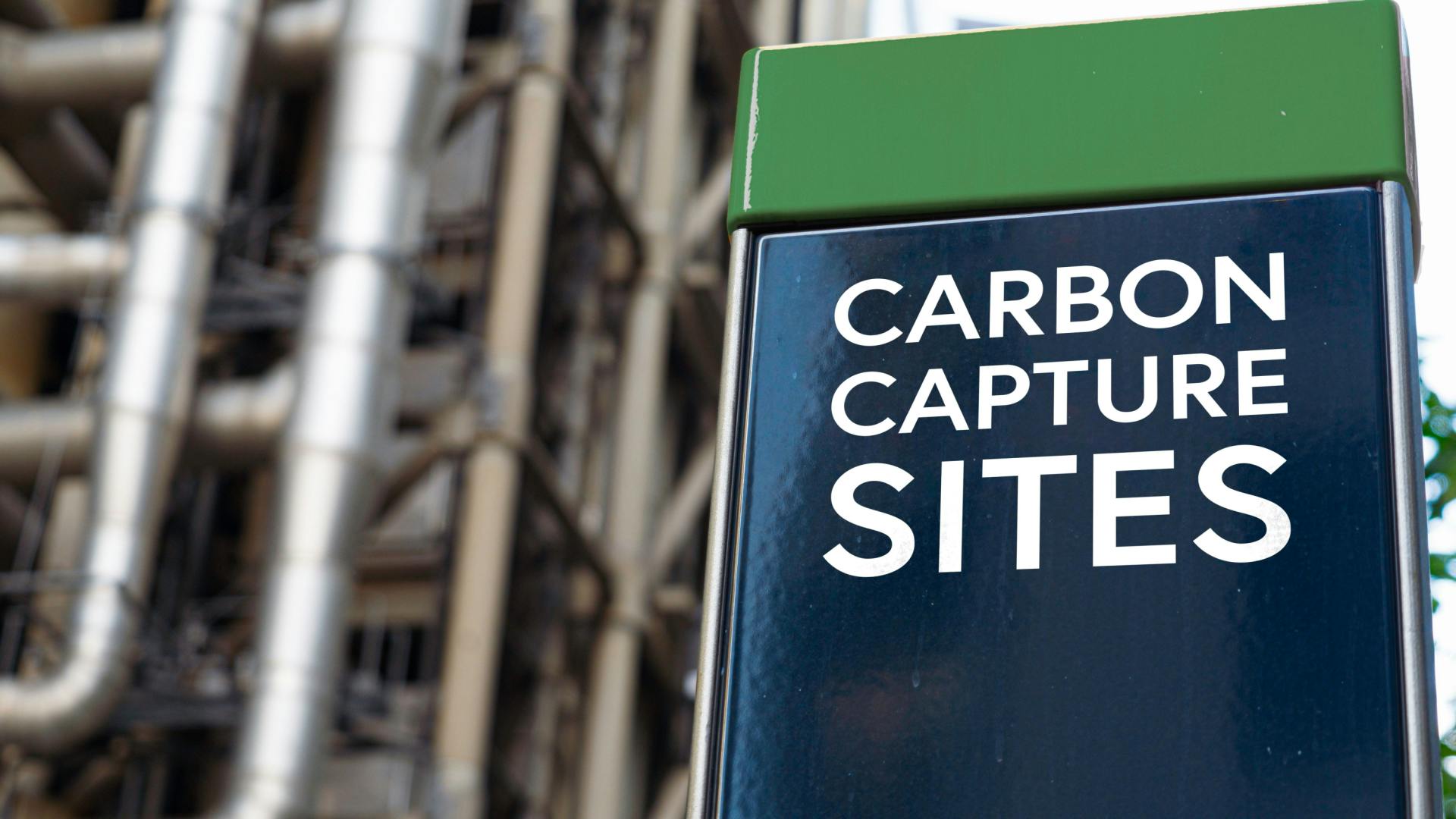 Carbon Capture sites on a sign in front of an Industrial building