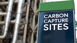 Carbon Capture sites on a sign in front of an Industrial building Carbon Capture sites on a sign in front of an Industrial building