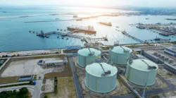LNG (Liquified Natural Gas) tanker anchored in Gas terminal gas tanks for storage.