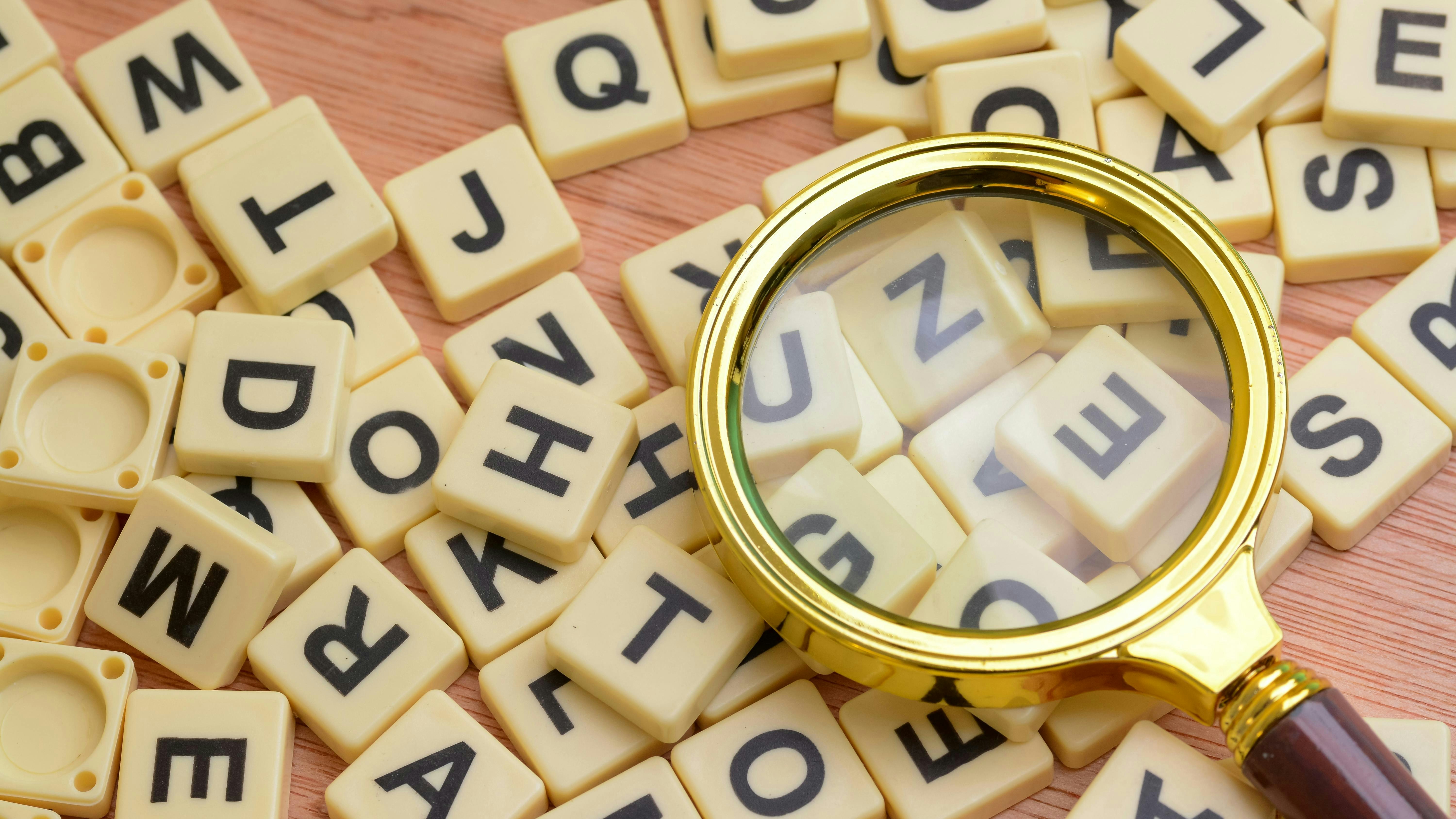 Chemical Processing Word Play: image shows scrabble letters under a magnifying glass