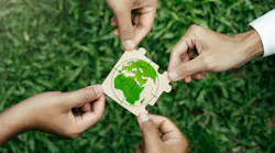 hands hold puzzle pieces that put together to show globe representing sustainability