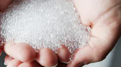 cupped hands hold pastic resin pellets