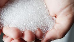 cupped hands hold pastic resin pellets cupped hands hold pastic resin pellets