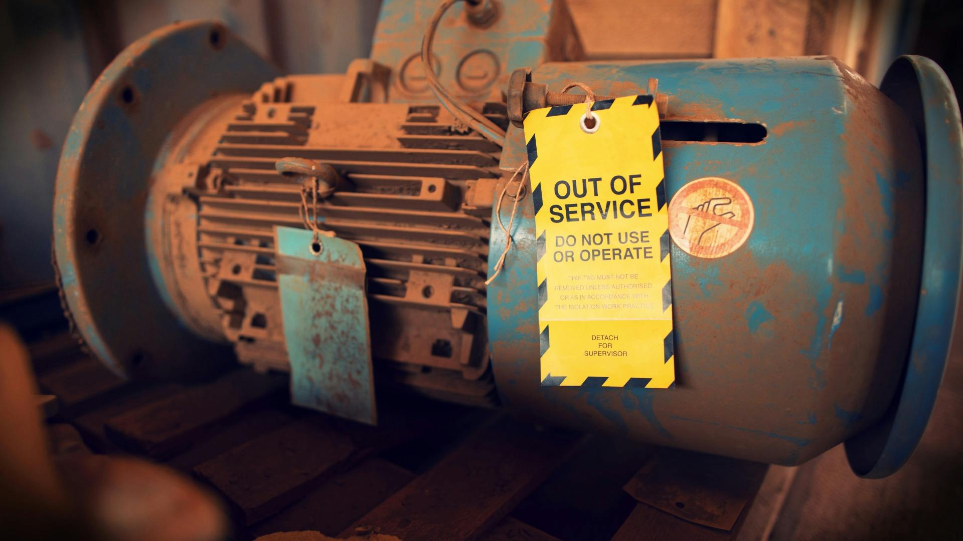 Safety workplaces yellow out of service tag attached on faulty damage defect of electric power motor.