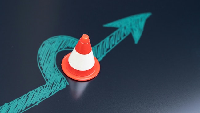 Chalk drawing arrow turn or break through road block traffic pylon on dark blackboard using as obstacle, solution for business problem or break through to success concept