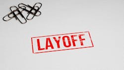 LAYOFF rubber stamp on paper with paper pins in the background. LAYOFF rubber stamp on paper with paper pins in the background.