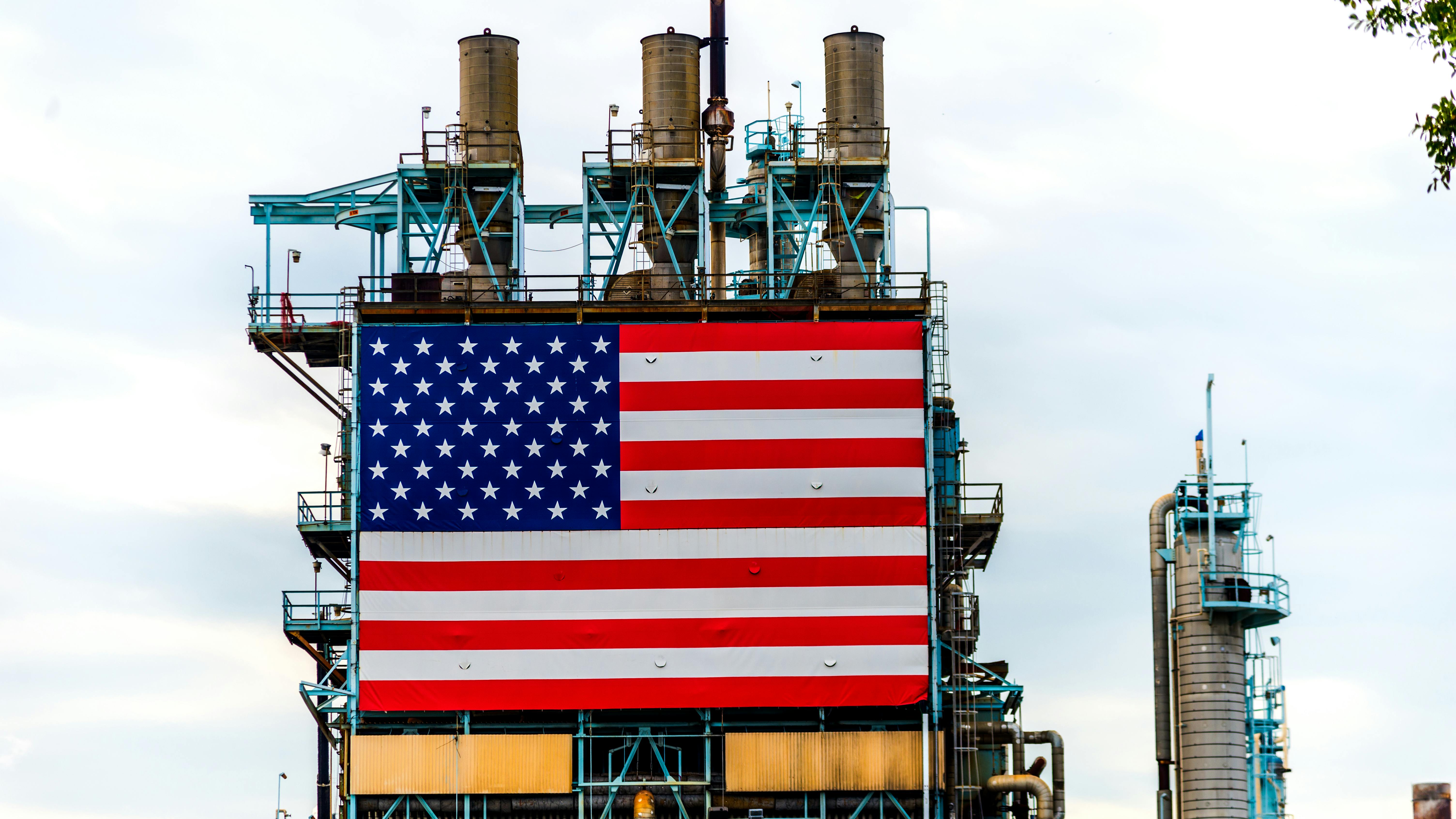 Large American Flag affixed to oil refinery platform in California