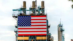 Large American Flag affixed to oil refinery platform in California