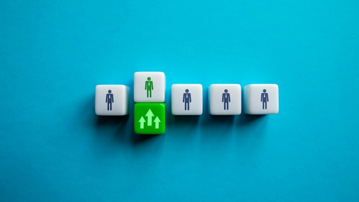 square cubes with people icons on them on blue background