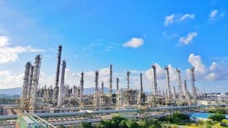 Tower refinery of chemical plant for thermal gas naphtha propylene and ethylene cracker with beautiful blue sky Tower refinery of chemical plant for thermal gas naphtha propylene and ethylene cracker with beautiful blue sky
