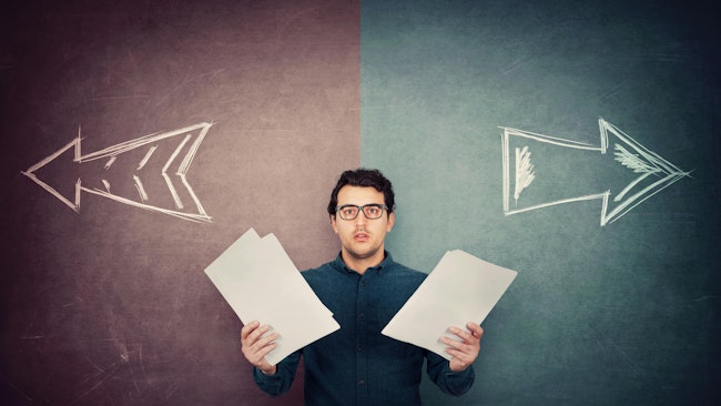 Perplexed businessman has to choose as holds different paper documents in both hands.