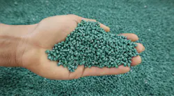 Plastic pellets for production, plastic polymer dye granules color green.