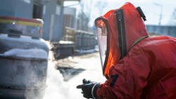 Firefighters in protective chemical HAZMAT suits stop chemical leak Firefighters in protective chemical HAZMAT suits stop chemical leak
