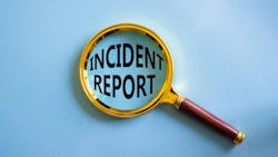 magnifying glass over the words incident report on blue background magnifying glass over the words incident report on blue background
