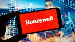 Honeywell on phone screen with digital market in background Honeywell on phone screen with digital market in background