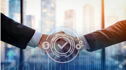Two business professionals in formal attire shaking hands across a table, symbolizing partnership or successful agreement in a modern office setting. Two business professionals in formal attire shaking hands across a table, symbolizing partnership or successful agreement in a modern office setting.