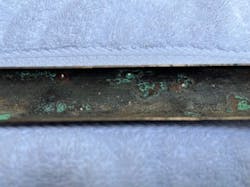 Photo of a split section of an extracted tube, with three through-wall penetrations within approximately 8 cm. Photo of a split section of an extracted tube, with three through-wall penetrations within approximately 8 cm.